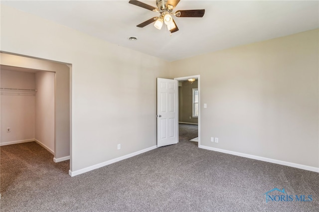 221 Poplar St, North Baltimore, OH 45872 - unfurnished bedroom with carpet, baseboards, a ceiling fan, and a spacious closet