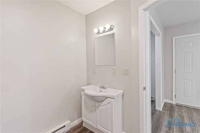 221 Poplar St, North Baltimore, OH 45872 - bathroom with wood finished floors, baseboards, and vanity
