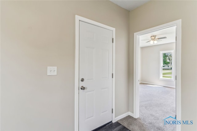 221 Poplar St, North Baltimore, OH 45872 - foyer featuring baseboards and dark carpet