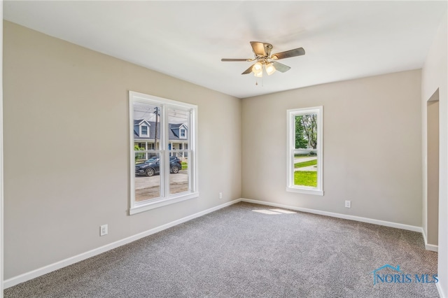 221 Poplar St, North Baltimore, OH 45872 - spare room with a ceiling fan, baseboards, and carpet floors