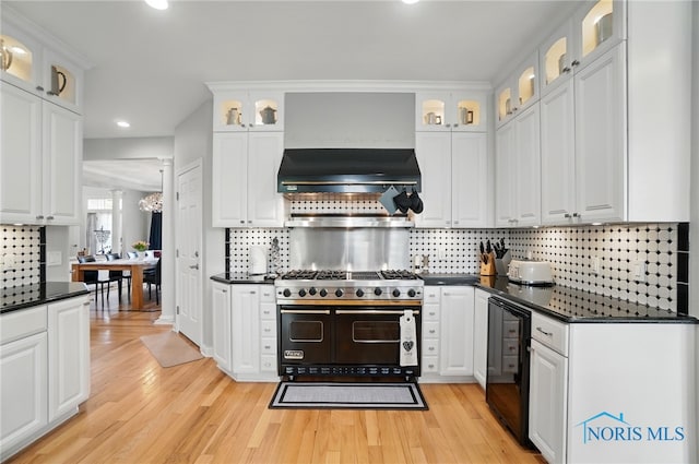 kitchen featuring dark countertops, wine cooler, tasteful backsplash, light wood finished floors, and recessed lighting