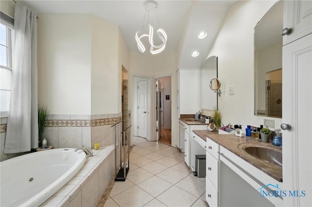 bathroom featuring a tub with jets, vanity, tile patterned floors, and recessed lighting