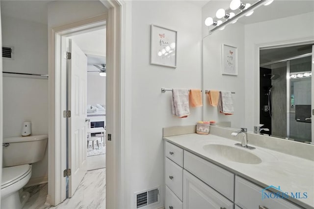 full bathroom with toilet, marble finish flooring, vanity, a shower with shower door, and ceiling fan