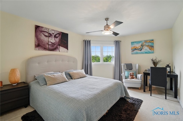 bedroom featuring light carpet and a ceiling fan
