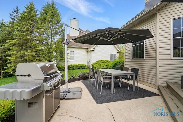 view of patio / terrace with outdoor dining space and grilling area