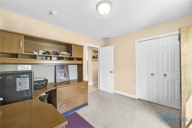 carpeted office featuring baseboards