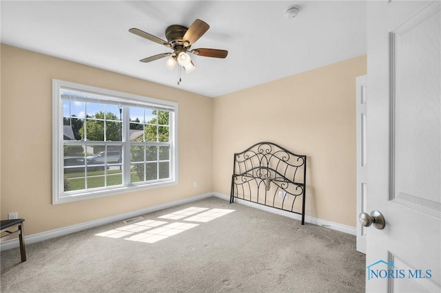 unfurnished bedroom with carpet floors, baseboards, and ceiling fan
