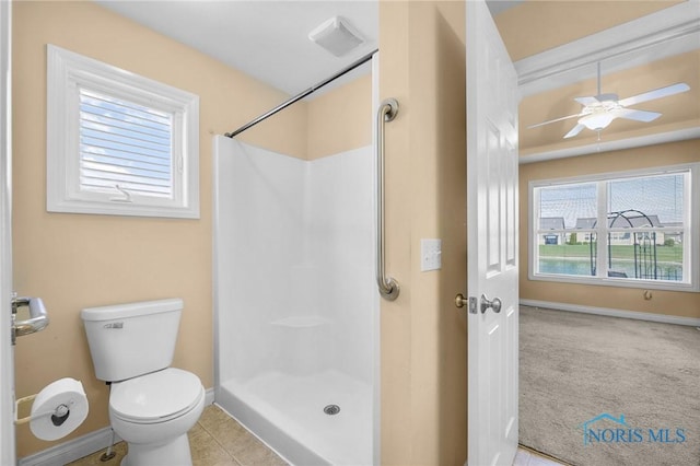 bathroom with baseboards, walk in shower, toilet, and ceiling fan