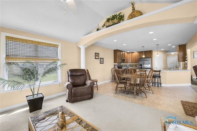 living room featuring ornate columns, recessed lighting, a ceiling fan, arched walkways, and baseboards