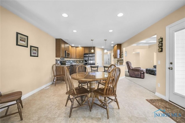 dining area featuring recessed lighting, light tile patterned flooring, and baseboards
