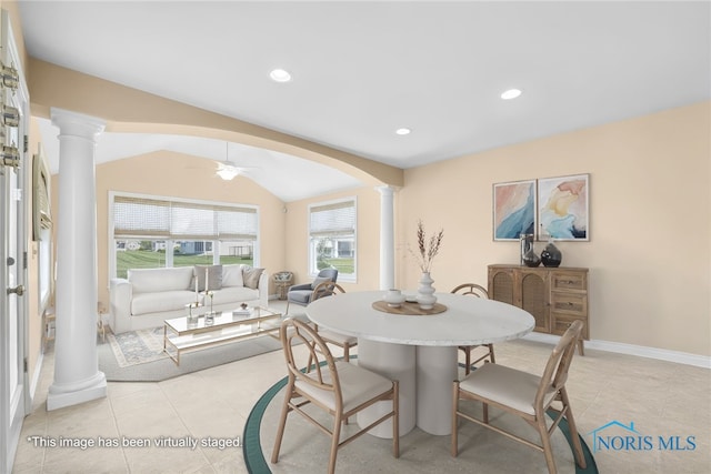 dining space with ornate columns, arched walkways, light tile patterned floors, vaulted ceiling, and a ceiling fan