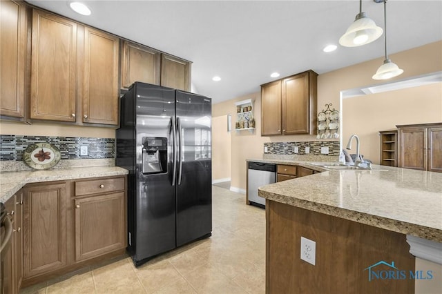 kitchen with black fridge, dishwasher, a sink, backsplash, and recessed lighting