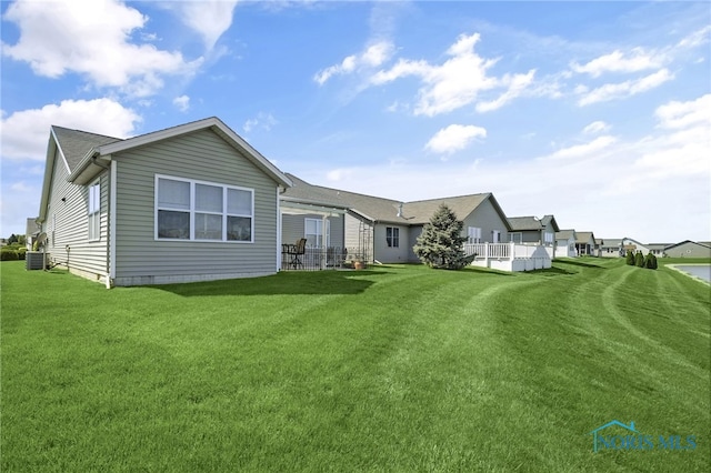 back of house with a lawn