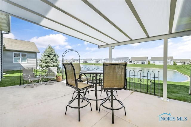 view of patio with a water view and a residential view