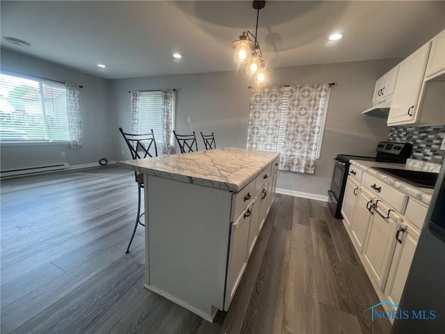 118 N Main St, Bloomdale, OH 44817 - kitchen featuring electric range, baseboard heating, a center island, dark wood-style flooring, and light countertops