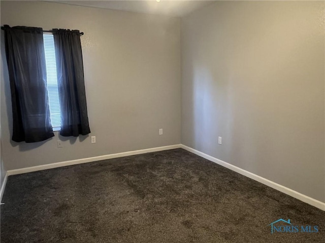 118 N Main St, Bloomdale, OH 44817 - empty room featuring dark colored carpet and baseboards