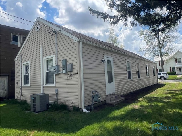118 N Main St, Bloomdale, OH 44817 - view of home's exterior with entry steps, cooling unit, and a lawn
