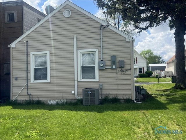 118 N Main St, Bloomdale, OH 44817 - view of side of home with a lawn and central AC unit