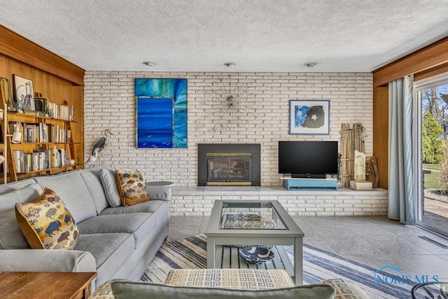 4426 Sheraton Rd, Ottawa Hills, OH 43615 - living area featuring a brick fireplace, wood walls, a textured ceiling, and brick wall