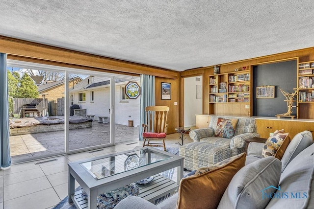 4426 Sheraton Rd, Ottawa Hills, OH 43615 - tiled living room featuring wooden walls and a textured ceiling