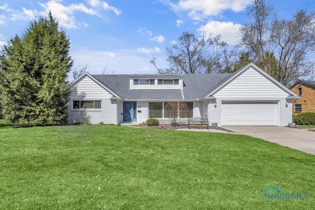 4426 Sheraton Rd, Ottawa Hills, OH 43615 - view of front of property with an attached garage, driveway, a shingled roof, a front yard, and brick siding