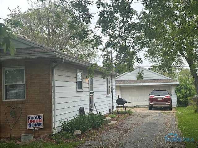 1217 Freedom St, Toledo, OH 43605 - view of side of home featuring a garage