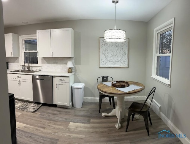 613 W Yeasting St, Gibsonburg, OH 43431 - kitchen with stainless steel dishwasher, a sink, baseboards, backsplash, and white cabinetry