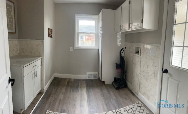 613 W Yeasting St, Gibsonburg, OH 43431 - washroom with hookup for a washing machine, wood finished floors, cabinet space, and baseboards