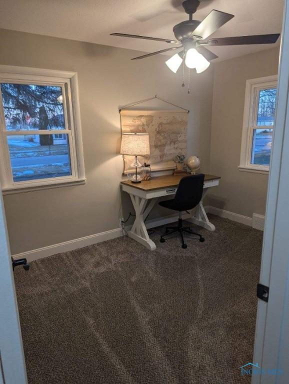 613 W Yeasting St, Gibsonburg, OH 43431 - home office featuring dark colored carpet, baseboards, and ceiling fan