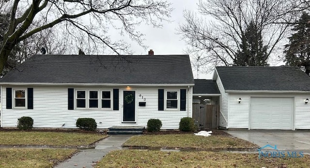 613 W Yeasting St, Gibsonburg, OH 43431 - cape cod-style house with a chimney, an attached garage, a front yard, and driveway