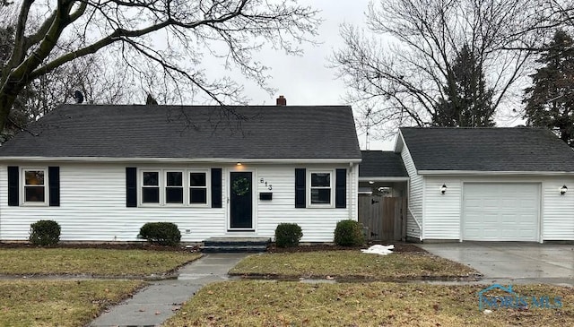 613 W Yeasting St, Gibsonburg, OH 43431 - cape cod house with a chimney, an attached garage, a front yard, and concrete driveway
