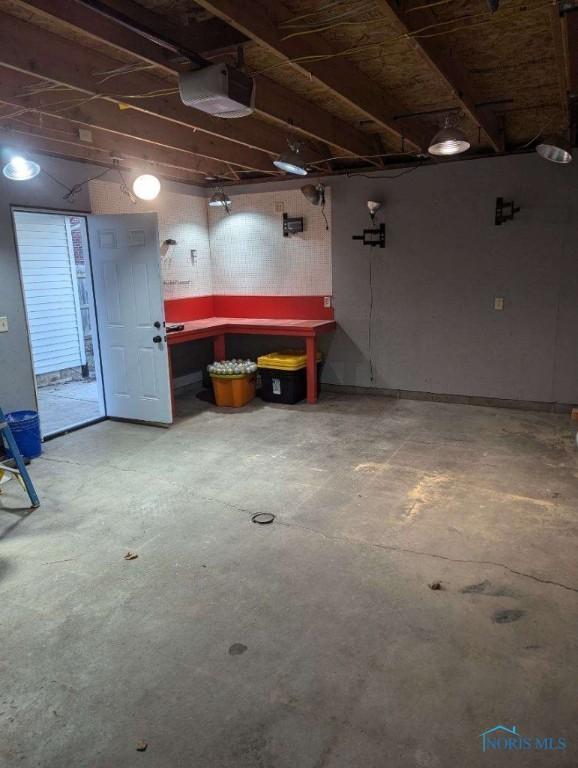 613 W Yeasting St, Gibsonburg, OH 43431 - garage featuring a garage door opener and a workshop area