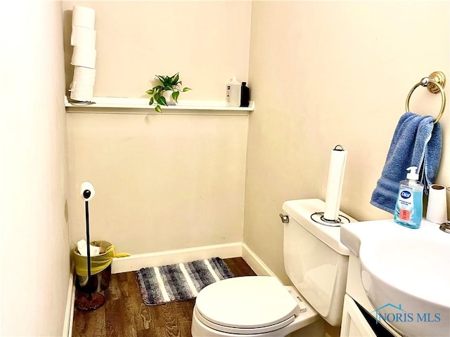 405 W Richards Rd, Toledo, OH 43607 - bathroom with wood finished floors, a sink, baseboards, and toilet