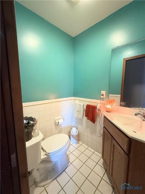 801 W Sandusky St, Findlay, OH 45840 - half bath with a wainscoted wall, toilet, tile patterned floors, tile walls, and vanity