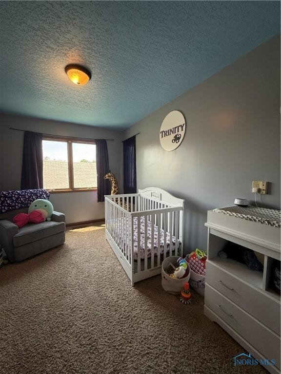 801 W Sandusky St, Findlay, OH 45840 - carpeted bedroom with a textured ceiling and a crib