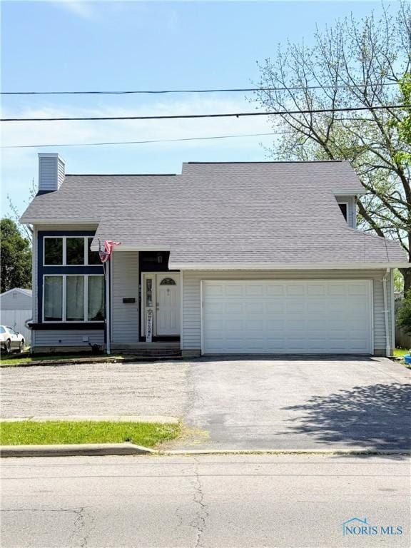 801 W Sandusky St, Findlay, OH 45840 - view of front of property with driveway, a chimney, a shingled roof, and a garage