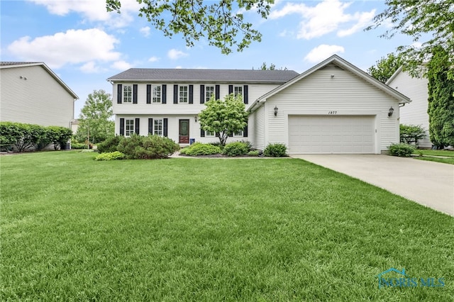 1977 Lexington Dr, Perrysburg, OH 43551 - colonial-style house featuring an attached garage, concrete driveway, and a front lawn