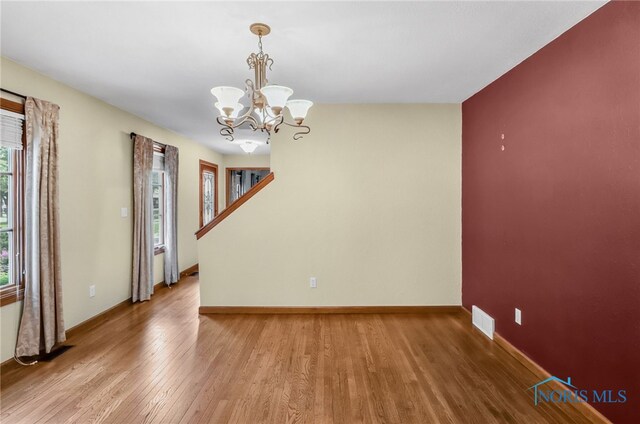 1977 Lexington Dr, Perrysburg, OH 43551 - unfurnished room featuring light wood-style flooring, a chandelier, and baseboards