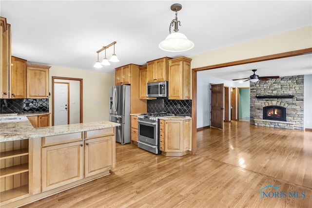 1977 Lexington Dr, Perrysburg, OH 43551 - kitchen featuring stainless steel appliances, a ceiling fan, light wood-style flooring, open floor plan, and decorative backsplash