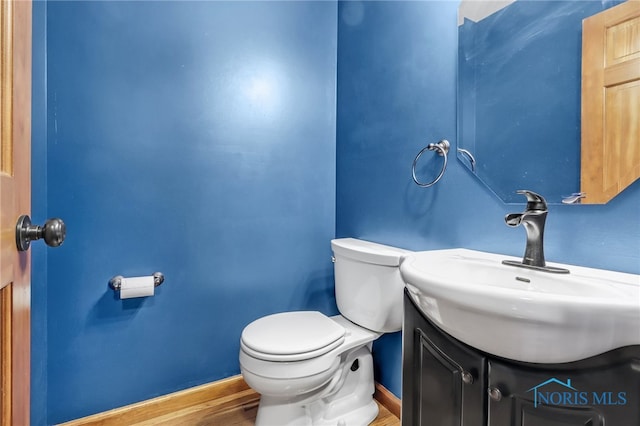 1977 Lexington Dr, Perrysburg, OH 43551 - bathroom featuring vanity, toilet, wood finished floors, and baseboards