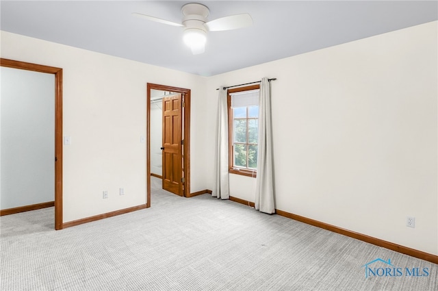 1977 Lexington Dr, Perrysburg, OH 43551 - unfurnished bedroom featuring a walk in closet, light colored carpet, baseboards, and a ceiling fan