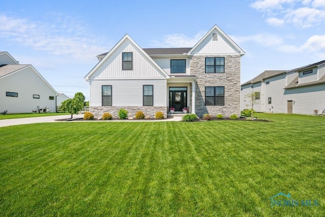 5653 Mallard Pointe Ln, Sylvania, OH 43560 - view of front of house with stone siding, board and batten siding, and a front lawn