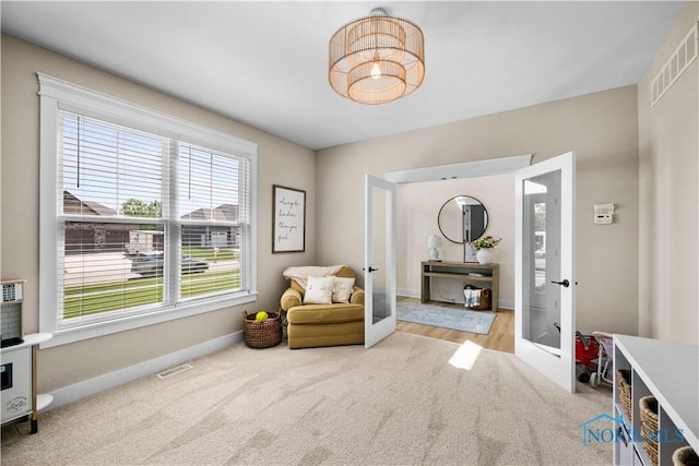 5653 Mallard Pointe Ln, Sylvania, OH 43560 - living area with french doors, carpet flooring, and baseboards