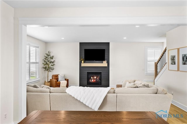 5653 Mallard Pointe Ln, Sylvania, OH 43560 - living room featuring wood finished floors, a large fireplace, baseboards, recessed lighting, and stairs
