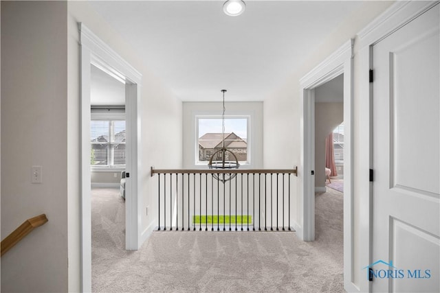 5653 Mallard Pointe Ln, Sylvania, OH 43560 - corridor featuring carpet floors, baseboards, and a chandelier
