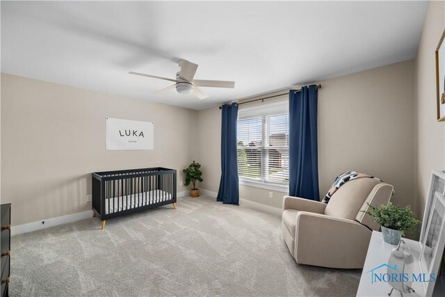 5653 Mallard Pointe Ln, Sylvania, OH 43560 - bedroom with baseboards, carpet floors, a ceiling fan, and a crib