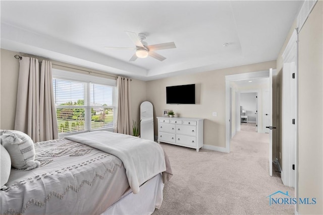5653 Mallard Pointe Ln, Sylvania, OH 43560 - bedroom featuring light colored carpet, a tray ceiling, baseboards, and a ceiling fan