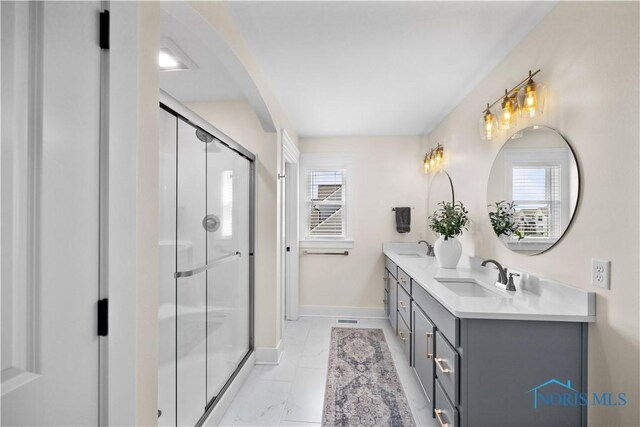 5653 Mallard Pointe Ln, Sylvania, OH 43560 - bathroom with double vanity, baseboards, a shower stall, and healthy amount of natural light