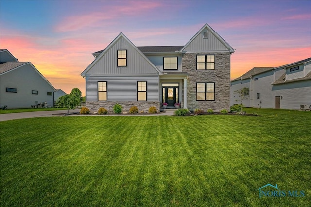 5653 Mallard Pointe Ln, Sylvania, OH 43560 - view of front facade featuring stone siding, board and batten siding, and a yard