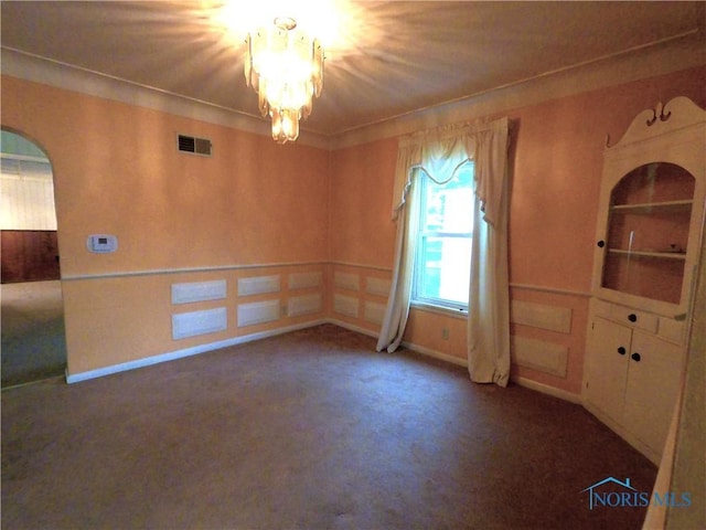 651 Park St, Napoleon, OH 43545 - spare room with carpet floors, arched walkways, and a chandelier